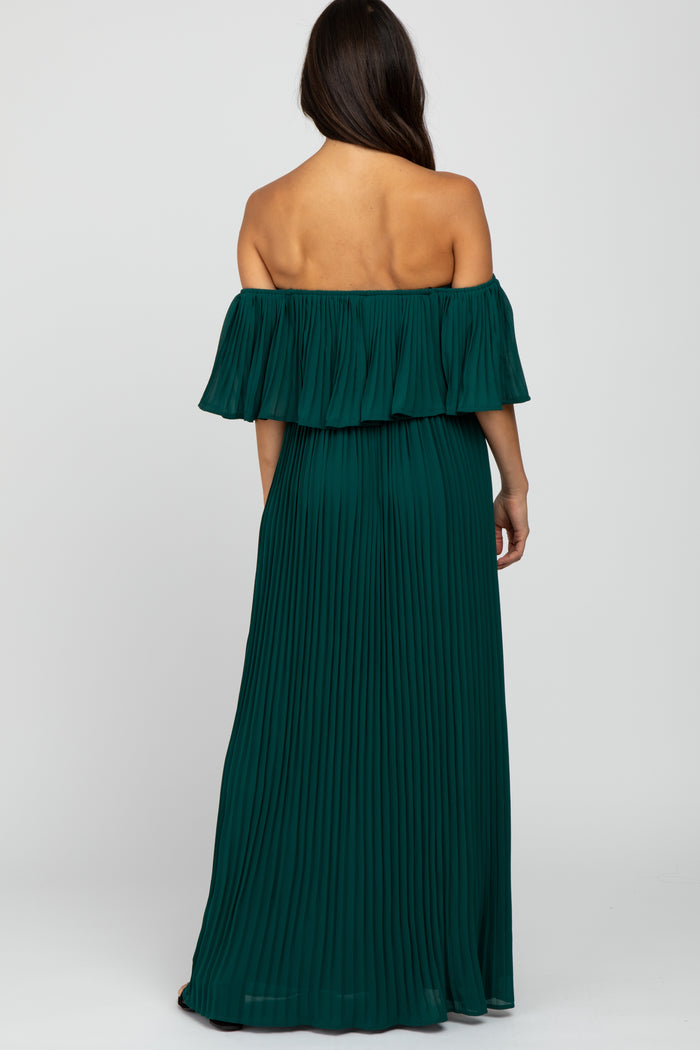 Back view of a woman wearing a forest green off-the-shoulder pleated maxi dress